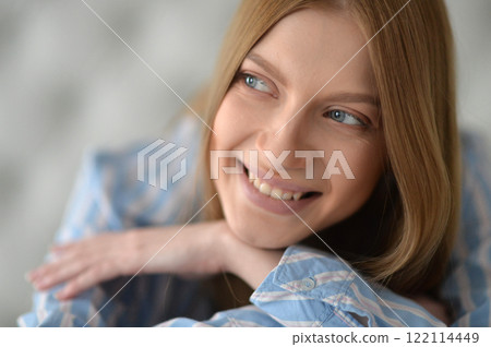 Beauty portrait. Young woman on grey wall background. Beauty portrait. Young woman on grey wall background. 122114449