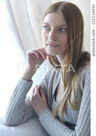 Beauty portrait. Young woman on grey wall background. Beauty portrait. Young woman on grey wall background. 122114450