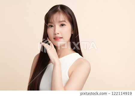 Beautiful young asian woman with clean fresh skin on beige background, Face care, Facial treatment, Cosmetology, beauty and spa, Asian women portrait. Beautiful young asian woman with clean fresh skin on beige background, Face care, Facial treatment, Cosmetology, beauty and spa, Asian women portrait. 122114919