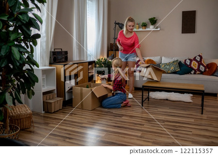 Unpacking Boxes Together in a Warm and Cozy Living Room Filled with Style and Comfort Unpacking Boxes Together in a Warm and Cozy Living Room Filled with Style and Comfort 122115357