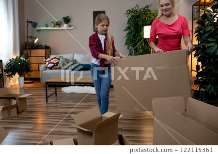 Relishing in precious Family Bonding Moments While Unpacking Moving Boxes Together as a Team 122115361