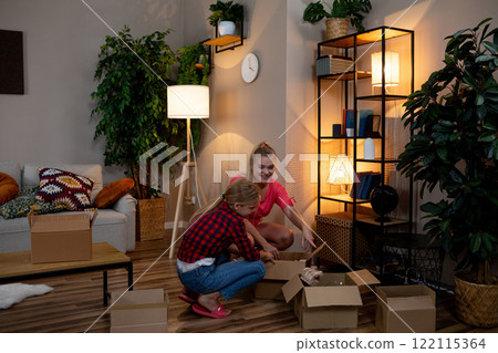 Exploring and Unpacking Joyful Moments in a Cozy Living Room Filled with Warmth and Comfort 122115364