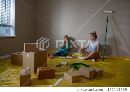 Children Joyfully Playing Amongst Moving Boxes in a Newly Painted Room Full of Color Children Joyfully Playing Amongst Moving Boxes in a Newly Painted Room Full of Color 122115369