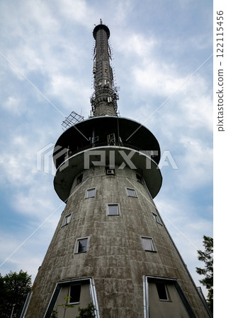 An Iconic Communication Tower Stands Majestically Against a Beautifully Cloudy Sky Above 122115456