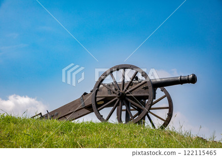 A Historic Cannon Situated on a Hill Under a Clear Blue Sky, Evoking Memories of the Past A Historic Cannon Situated on a Hill Under a Clear Blue Sky, Evoking Memories of the Past 122115465