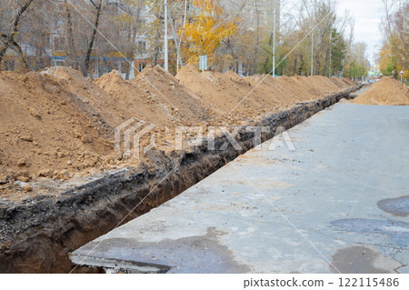 a long, narrow, deep trench on a city roadway for laying a city water pipeline or water pipe. Repair repair of city water supply in a deep trench on a city street. Improving the quality of life 122115486