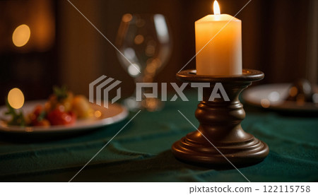Candlelit dinner setting with elegant table arrangements and delicious food served in a cozy atmosphere 122115758
