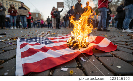 Protesters gather to demonstrate with a burning flag on the street during a heated rally for social justice 122116193