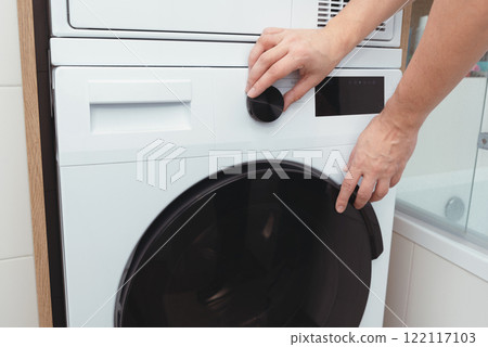 White washing machine in a utility room 122117103