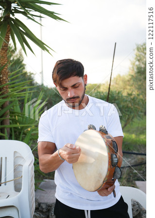 Joyful Tambourine Beats in Rolling Countryside Joyful Tambourine Beats in Rolling Countryside 122117516