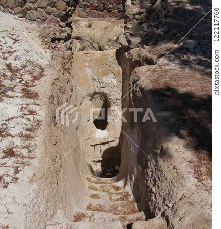 Entrance to a rough water well in a sandy desert in an oasis. Descent with a rope ladder. Above is a stone. Entrance to a rough water well in a sandy desert in an oasis. Descent with a rope ladder. Above is a stone. 122117760