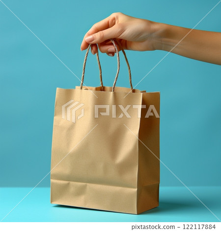 Hand Holding Eco-Friendly Kraft Paper Bag Hand Holding Eco-Friendly Kraft Paper Bag 122117884