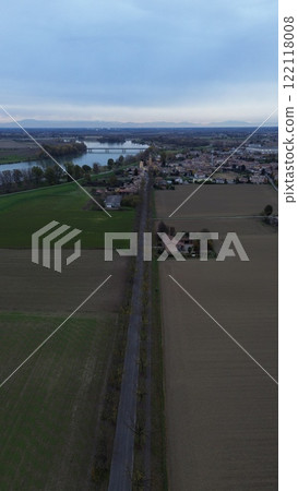 Vertical aerial view of san nazzaro, monticelli d'ongina, italy, showing road, trees, fields, and houses in autumn 122118008