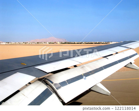 Airplane Wing Over the Sandy Landscape of Sharm El Sheikh During Descent Airplane Wing Over the Sandy Landscape of Sharm El Sheikh During Descent 122118014