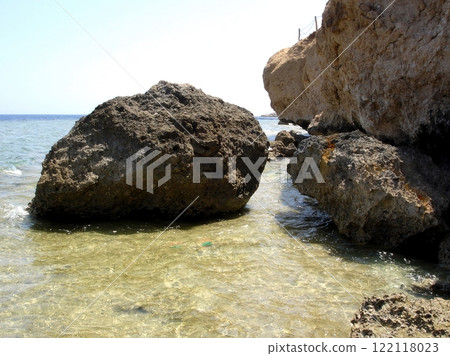 Rocky Desert Shore Along the Tranquil Waters of the Red Sea in Bright Daylight 122118023