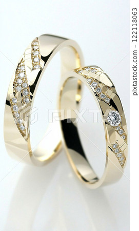 Two gold wedding rings resting on white cloth 122118063