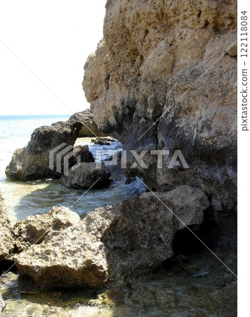 The rocky shores of the Red Sea showcase clear waters and unique rock formations under the sun The rocky shores of the Red Sea showcase clear waters and unique rock formations under the sun 122118084