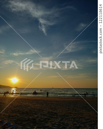 Busy beach at sunset, Phuket island, Thailand Busy beach at sunset, Phuket island, Thailand 122118614