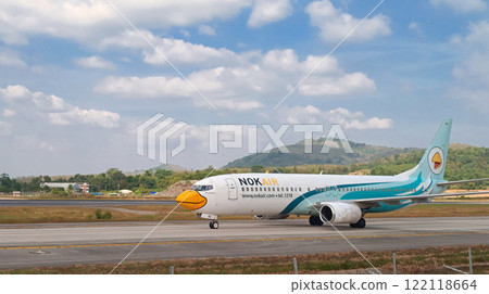 PHUKET, THAILAND, JANUARY 14, 2025 Nok Airlines commercial flight going to parking position after landing in popular touristic Island Phuket in Thailand on January 14, 2025 PHUKET, THAILAND, JANUARY 14, 2025 Nok Airlines commercial flight going to parking position after landing in popular touristic Island Phuket in Thailand on January 14, 2025 122118664