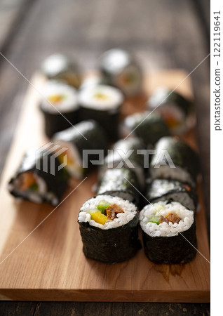 Homemade sushi rolls served on a wooden board Homemade sushi rolls served on a wooden board 122119641