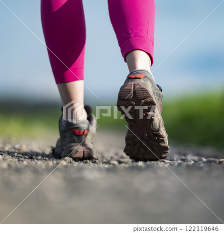 Low angle view of hiking shoes on female legs Low angle view of hiking shoes on female legs 122119646
