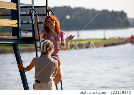 Enjoying the Summer by the Water Engaging Conversations and Relaxation with Friends and Fun 122119870