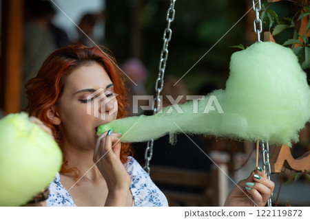 Enjoy a Delightful Cotton Candy Experience While on an Exciting Swing Ride at the Fair 122119872