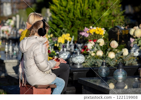 Visitors are Paying Respect at a Peaceful Cemetery During the Warm Daylight Hours Ahead 122119908