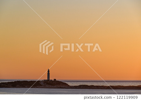 Beautiful sunset on the beach of Los Canos de Meca with the background of the Trafalgar Lighthouse, Barbate, Cadiz 122119909