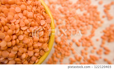 Red Split Lentils (Masoor Dal) in Yellow Bowl - Healthy Legume Closeup Flat lay Top View Red Split Lentils (Masoor Dal) in Yellow Bowl - Healthy Legume Closeup Flat lay Top View 122120403