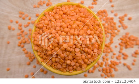 Red Lentils (Masoor Dal) Split and Dehusked in a Yellow Bowl - Rustic Close-Up Top View Flat Lay Red Lentils (Masoor Dal) Split and Dehusked in a Yellow Bowl - Rustic Close-Up Top View Flat Lay 122120404