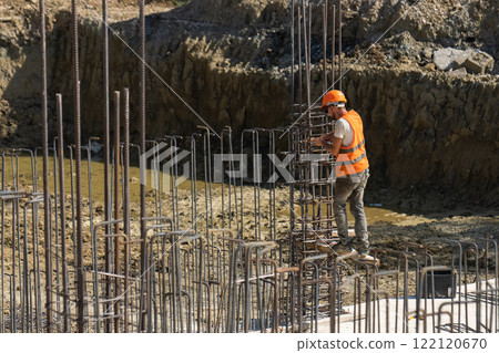 Builders work with reinforcement wire. Builders work with reinforcement wire. 122120670