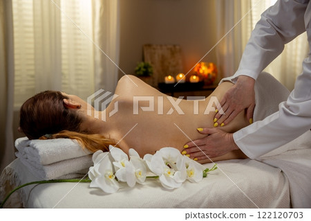Enjoy calming massage therapy in a serene spa, promoting overall wellness and tranquility Enjoy calming massage therapy in a serene spa, promoting overall wellness and tranquility 122120703