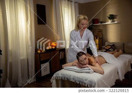 Engaging in a Relaxing Massage Session within a Tranquil and Peaceful Spa Environment Engaging in a Relaxing Massage Session within a Tranquil and Peaceful Spa Environment 122120815