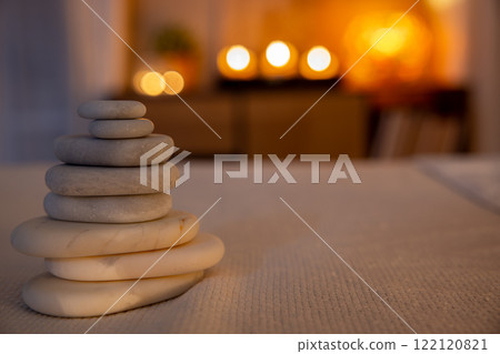Beautifully Peaceful Stacked Stones Arranged in a Serene Atmosphere with Soft Candlelight Beautifully Peaceful Stacked Stones Arranged in a Serene Atmosphere with Soft Candlelight 122120821