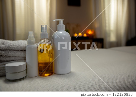 A collection of relaxing spa products elegantly arranged on a treatment table ready for use 122120833