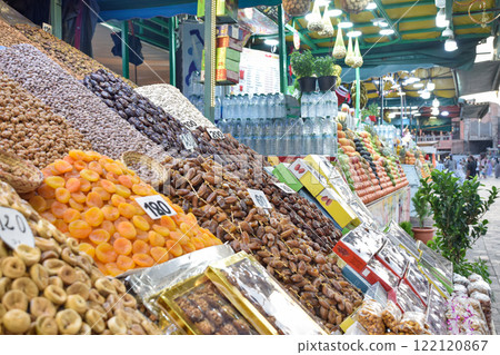 Dates, apricots, almonds and snacks displayed in business of Marrakech square 122120867