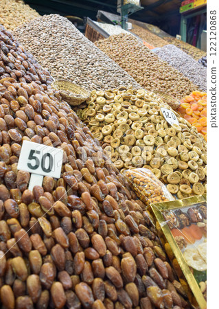 Dates, apricots, almonds and snacks displayed in business of Marrakech square 122120868
