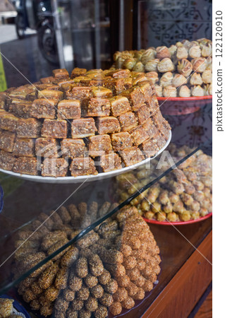 Typical baklava and almond sweets. Pastries stocked on Marrakesh market Typical baklava and almond sweets. Pastries stocked on Marrakesh market 122120910