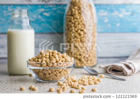 Sweet honey cereal rings in bowl on klitchen table. 122121369