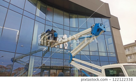 The essential maintenance of a glass facade using a boom lift is crucial for its upkeep The essential maintenance of a glass facade using a boom lift is crucial for its upkeep 122122338