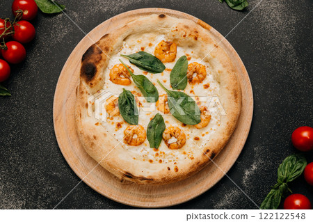 Delicious seafood pizza topped with juicy shrimp, spinach leaves, and melted mozzarella cheese 122122548