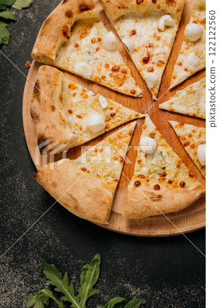 Cheesy pizza slices topped with mini mozzarella, ready to share for the perfect food moment Cheesy pizza slices topped with mini mozzarella, ready to share for the perfect food moment 122122560