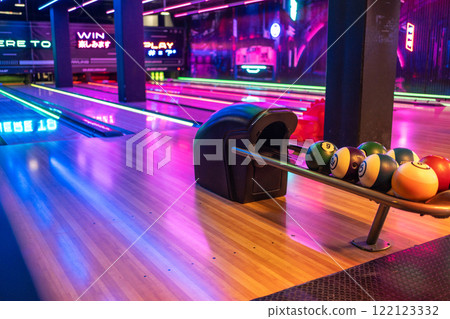 Various bowling balls arranged in stand at 122123332