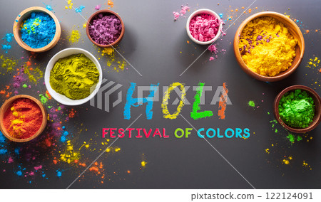 Happy Holi decoration, the indian festival.Top view of colorful holi powder and the text on dark background. Happy Holi decoration, the indian festival.Top view of colorful holi powder and the text on dark background. 122124091