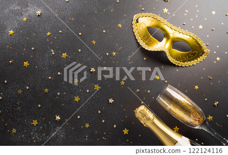 Happy Purim carnival decoration concept made from golden mask star and glitter on dark background. (Happy Purim in Hebrew, jewish holiday celebrate) 122124116