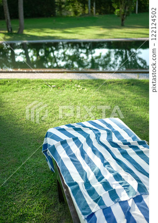 Pool towel on deckchair. Pool towel on deckchair. 122124502
