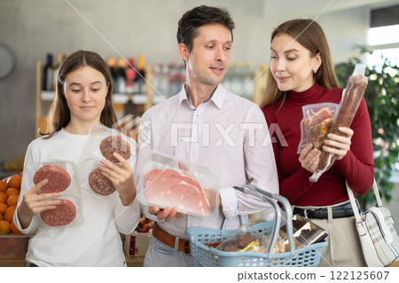 Man woman and girl choose hamburger, beef and dry meat Man woman and girl choose hamburger, beef and dry meat 122125607