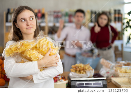 Parents scold girl with chips in grocery store Parents scold girl with chips in grocery store 122125793