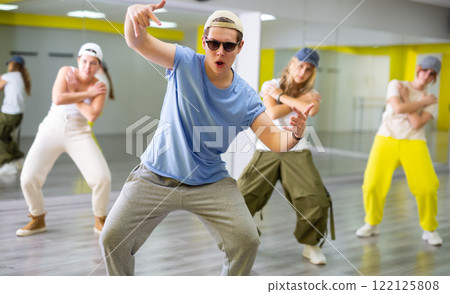 Young guy in sunglasses dancing modern dance Young guy in sunglasses dancing modern dance 122125808